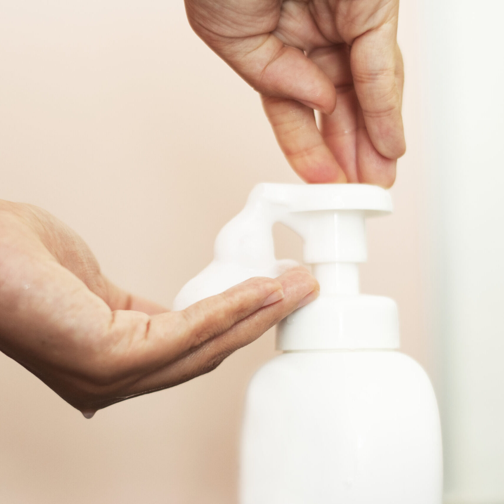 Woman using soap to clean hands and prevent coronavirus